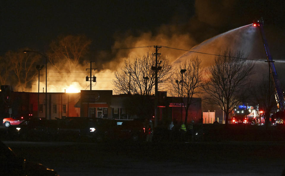 Fire departments battle an industrial fire near 15 Mile Road and Groesbeck Highway in the Detroit suburb of Clinton Township on Monday, March 4, 2024. (Robin Buckson/Detroit News via AP)