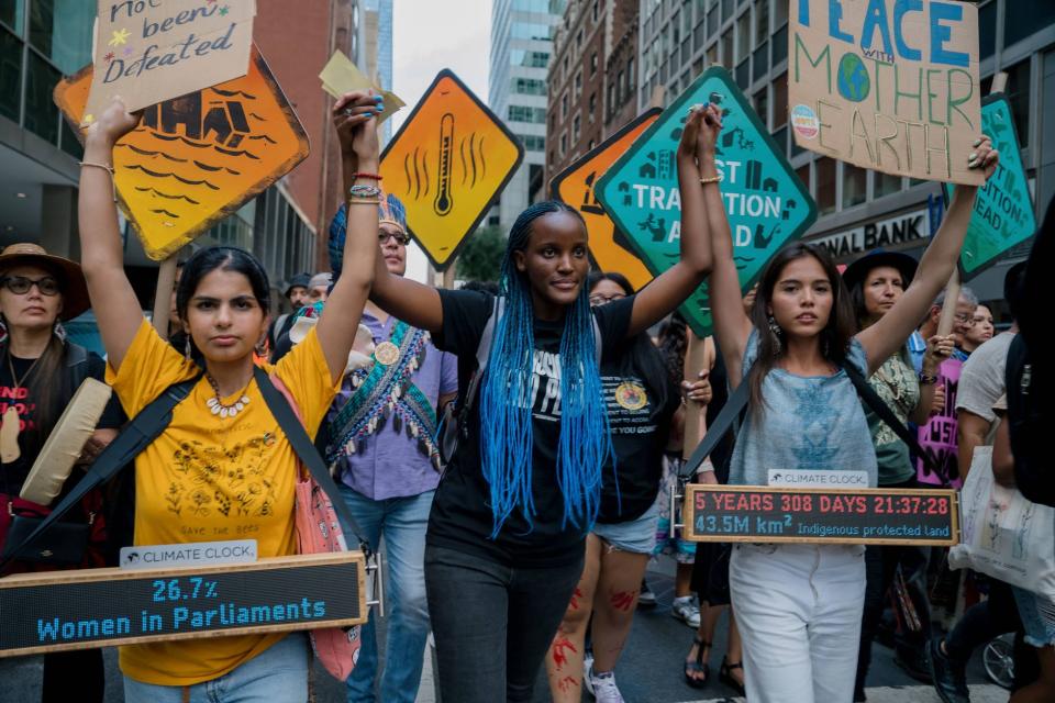 Ayisha Siddiqa (in yellow) marches with Xiye Bastida (blue shirt) on Sept 17 in NYC to stop fossil fuels