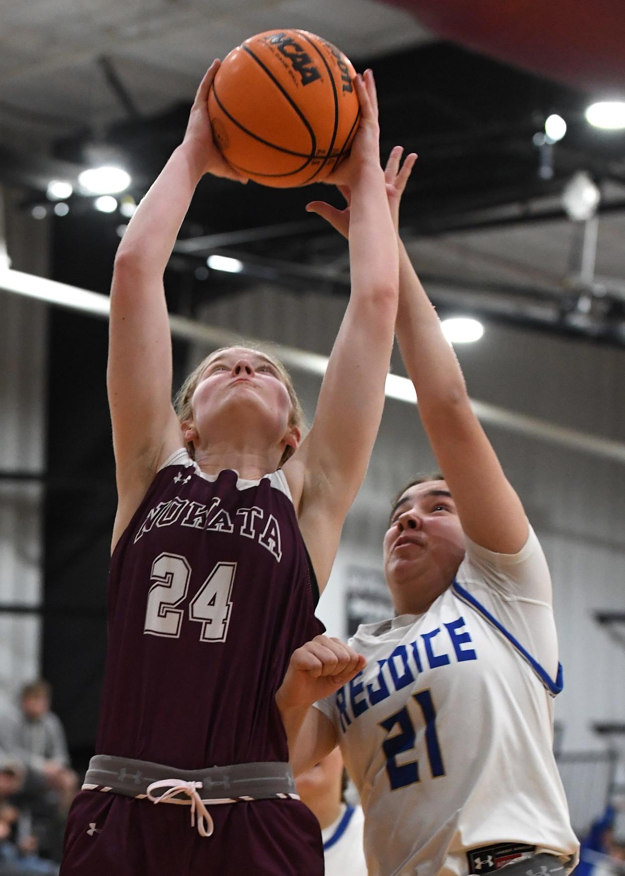 Nowata High School's Kaylee Bashford (24) grabs a rebound during basketball action at the Ty Hewitt Memorial Tournament in Nowata on Dec. 4, 2023. The Lady Ironmen defeated Rejoice Christian 44-38.