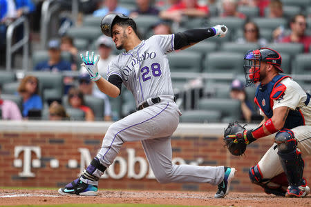 Aug 19, 2018; Atlanta, GA, USA; Colorado Rockies third baseman Nolan Arenado (28) looses his batting helmet on a swing against the Atlanta Braves during the third inning at SunTrust Park. Mandatory Credit: Dale Zanine-USA TODAY Sports