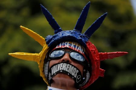 A demonstrator displays writing on this face that reads, "Freedom, we will return", as he attends a rally against Venezuela's President Nicolas Maduro's government in Caracas, Venezuela June 27, 2017. REUTERS/Ivan Alvarado