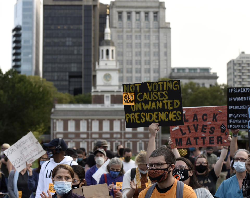 People gather at Independence Mall to protest U.S. President Donald Trump as he visits the National Constitution Center to participate in the ABC News town hall, Tuesday, Sept. 15, 2020, in Philadelphia. (AP Photo/Michael Perez)