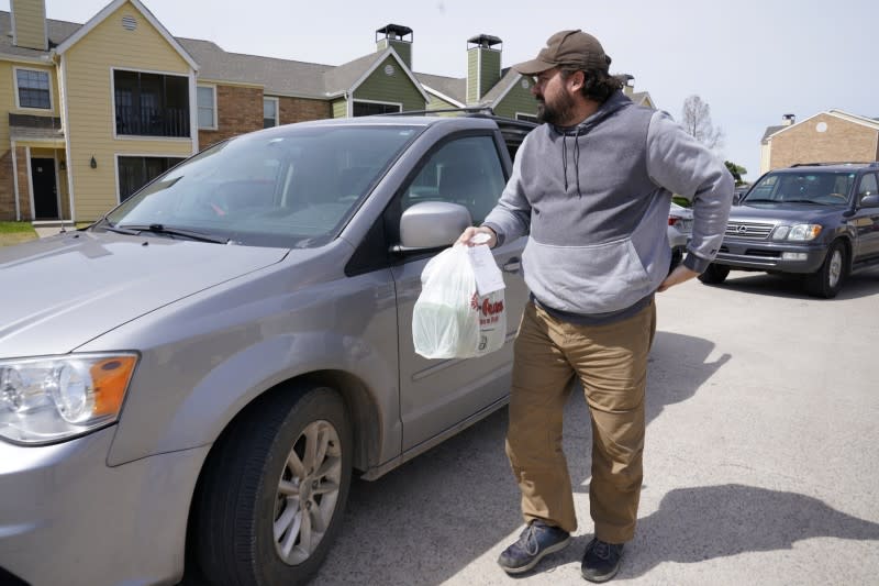 Chlebanowski looks for a customer's apartment to deliver produce that was ordered online in Norman