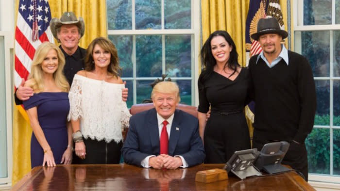 Sarah Palin, Ted Nugent and his wife, and Kid Rock and his fiancée posing with President Trump.