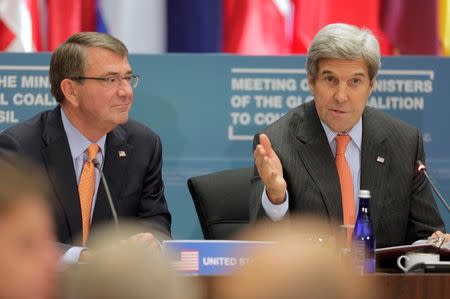 U.S. Secretary of State John Kerry (R) and U.S. Secretary of Defense Ash Carter speak at a "Meeting of the Ministers of the Global Coalition to Counter ISIL: Joint Plenary Session" at the State Department in Washington, U.S., July 21, 2016. REUTERS/Joshua Roberts