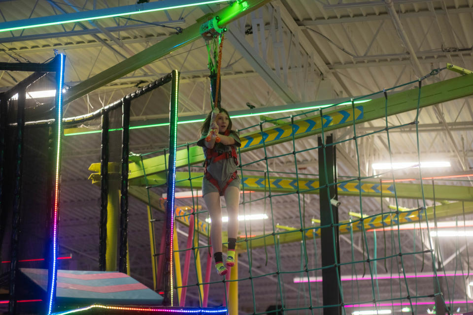 A young girl enjoys the zipline at Urban Air Amusement Park in Amarillo.