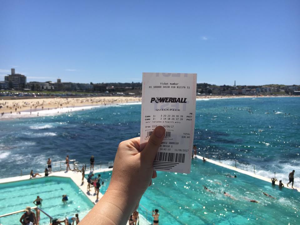 A Powerball lotto ticket with Sydney's Bondi Icebergs in the background.