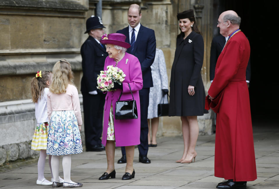 The queen wore&nbsp;a magenta hat and coat over a floral dress. (Photo: WPA Pool via Getty Images)