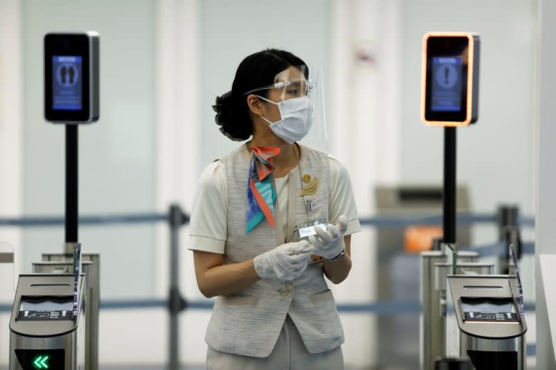 FILE PHOTO: An airport staff member stands at the Haneda airport in Tokyo