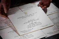 Invitations for Britain's Prince Harry and Meghan Markle's wedding in Windsor Castle in May, are seen after they have been printed at the workshop of Barnard and Westwood in London, March 22, 2018. Victoria Jones/Pool via Reuters