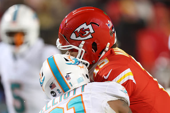 KANSAS CITY, MO – JANUARY 13: Kansas City Chiefs quarterback Patrick Mahomes (15) helmet cracks taking a hit from Miami Dolphins safety DeShon Elliott (21) in the third quarter of an AFC Wild Card playoff game between the Miami Dolphins and Kansas City Chiefs on Jan 13, 2024 at GEHA Field at Arrowhead Stadium in Kansas City, MO. (Photo by Scott Winters/Icon Sportswire via Getty Images)