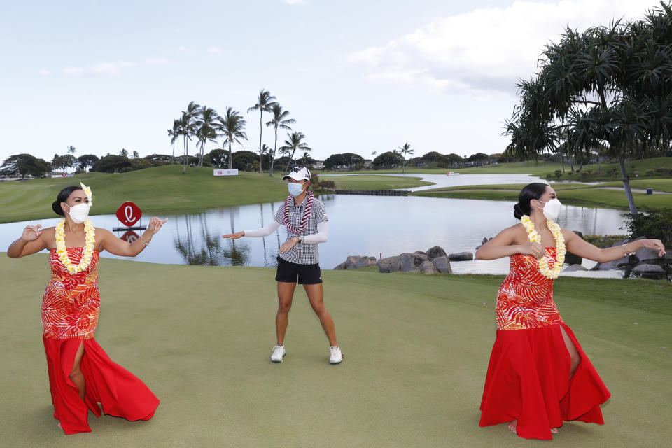 Lydia Ko, of New Zealand, center, performs a hula dance after winning the Lotte Championship golf tournament, Saturday, April 17, 2021, in Kapolei, Hawaii. (AP Photo/Marco Garcia)