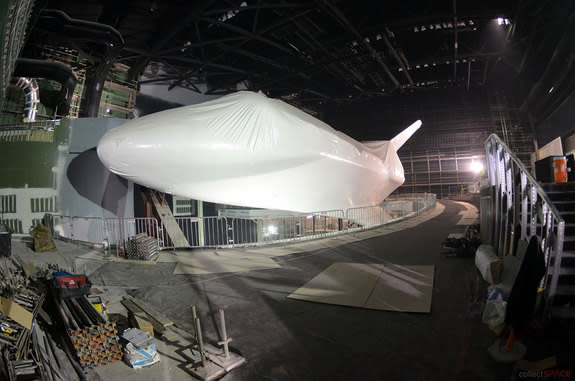 Since entering its six-story exhibit building at NASA’s Kennedy Space Center Visitor Complex in Florida in November 2012, space shuttle Atlantis has been raised off the ground, shrink-wrapped in 16,000 square feet of plastic and tilted 43 degre