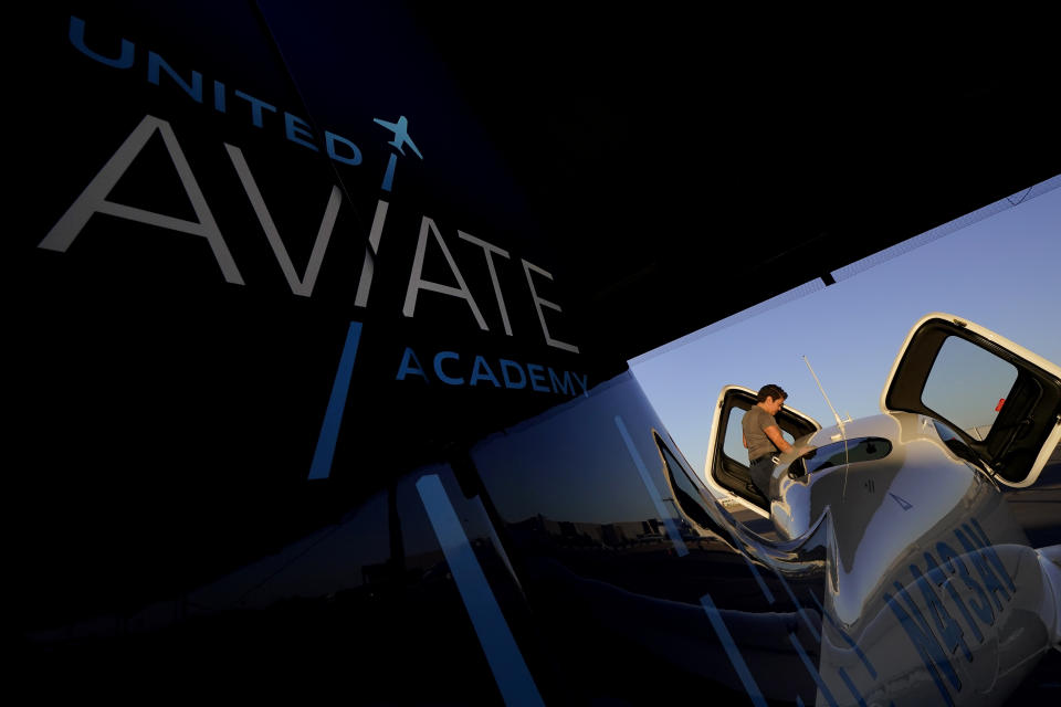 United Aviate Academy student pilot Ashley Montano inspects her aircraft prior to a flight, Friday, Oct. 28, 2022, in Goodyear, Ariz. Montano hopes that in a few years she will be flying airline jets. If she does, she'll be helping solve a critical problem facing the industry: not enough pilots. (AP Photo/Matt York)