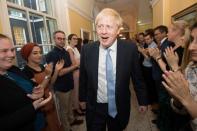 Britain's Prime Minister Boris Johnson is welcomed in 10 Downing Street by staff after meeting Britain's Queen Elizabeth II and accepting her invitation to become Prime Minister and form a new government