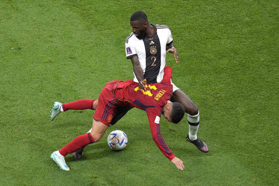 Germany's Antonio Ruediger, atop, challenges for the ball with Spain's Ferran Torres during the World Cup group E soccer match between Spain and Germany, at the Al Bayt Stadium in Al Khor, Qatar, Sunday, Nov. 27, 2022. (AP Photo/Ricardo Mazalan)