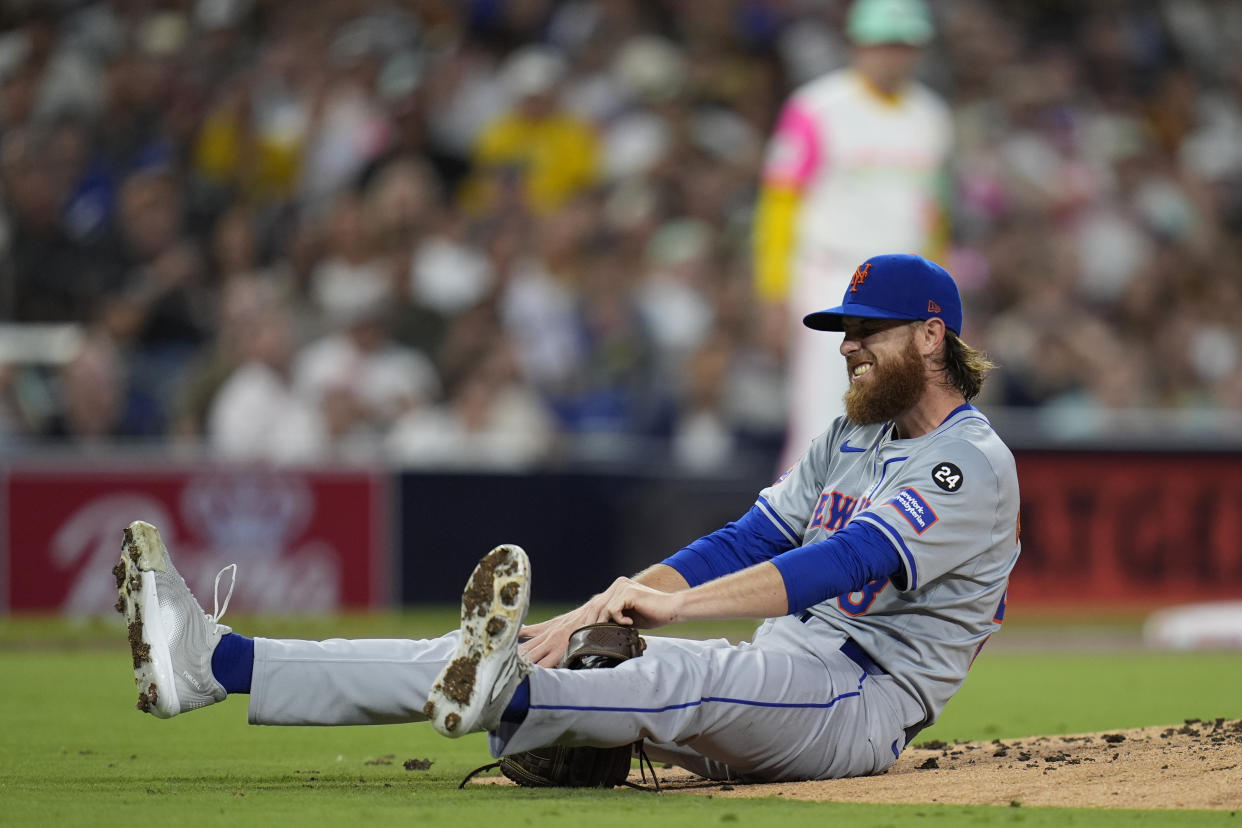 New York Mets starting pitcher Paul Blackburn stays down after getting hit by a line out by San Diego Padres' David Peralta during the third inning of a baseball game Friday, Aug. 23, 2024, in San Diego. (AP Photo/Gregory Bull)