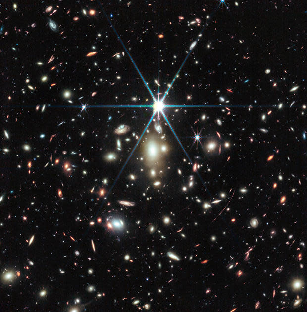 Earendel, the farthest star ever detected, is a massive B-type star, about a million times more luminous than our Sun. The gravitational forces of a galaxy cluster that exists between Earendel and us actually bends and magnifies the light of that star so that we can see it.  / Credit: Space Telescope Science Institute; NASA, ESA, CSA, Dan Coe (STScI/AURA for ESA, JHU), Brian Welch (NASA-GSFC, UMD), with image processing by Zolt G. Levay