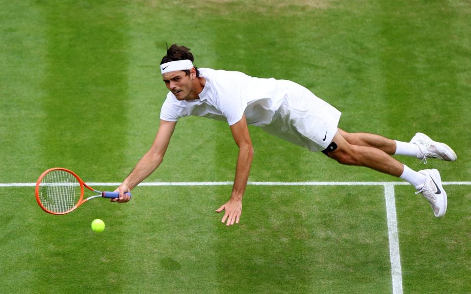 Tennis - Wimbledon - All England Lawn Tennis and Croquet Club, London, Britain - July 4, 2022 Taylor Fritz of the U.S. in action during his fourth round match against Australia's Jason Kubler  - Hannah McKay/Reuters