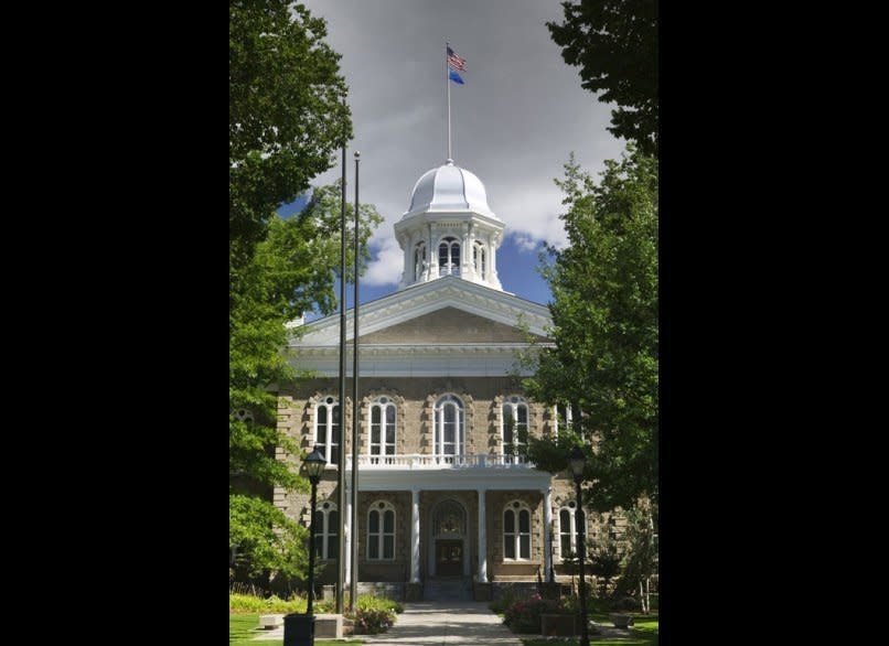 <strong>NEVADA STATE CAPITOL</strong>  Carson City, Nevada    <strong>Year completed: </strong>1871  <strong>Architectural style:</strong> Neo-Classical Italianate  <strong>FYI:</strong> After Nevada became a state, the constitutional convention made a provision that no state capitol would be built until after three legislative sessions, in case future leaders wanted to move the center of government away from Carson City. A ten-acre site set aside for the building remained empty. In his book Roughing It, Mark Twain describes the empty plaza as a useful spot for “public auctions, horse trades, mass meetings, and likewise for teamsters to camp in.”  <strong>Visit:</strong> The capitol is open Monday to Friday, from 8 a.m. to 5 p.m. (it is closed on weekends). Call the Education Program at the Nevada State Museum to arrange guided tours.  