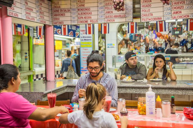 <p>Monica Gumm/laif/Redux</p> Diners at a food stall in the Central Market.