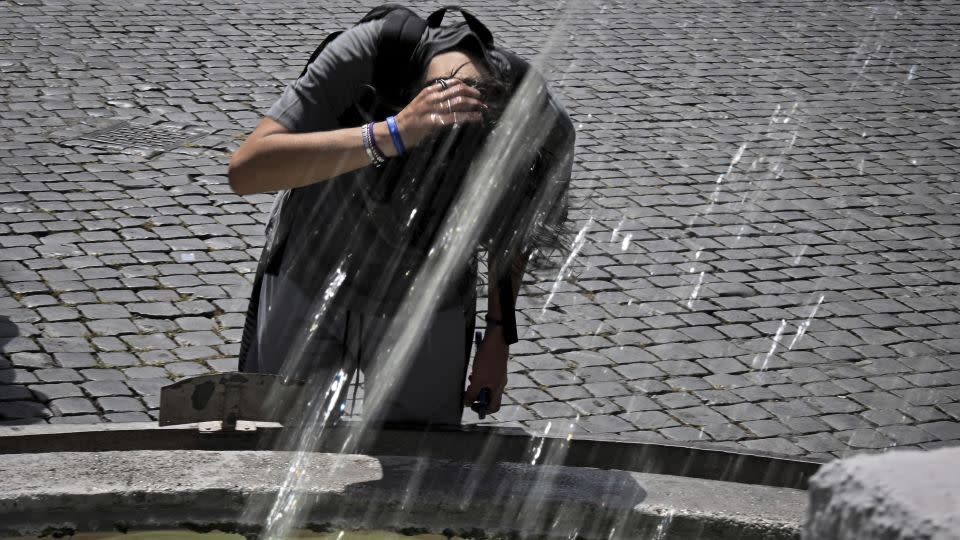 A boy cools down at the Piazza del Popolo fountain in Rome on July 17, 2023. - Tiziana Fabi/AFP/Getty Images