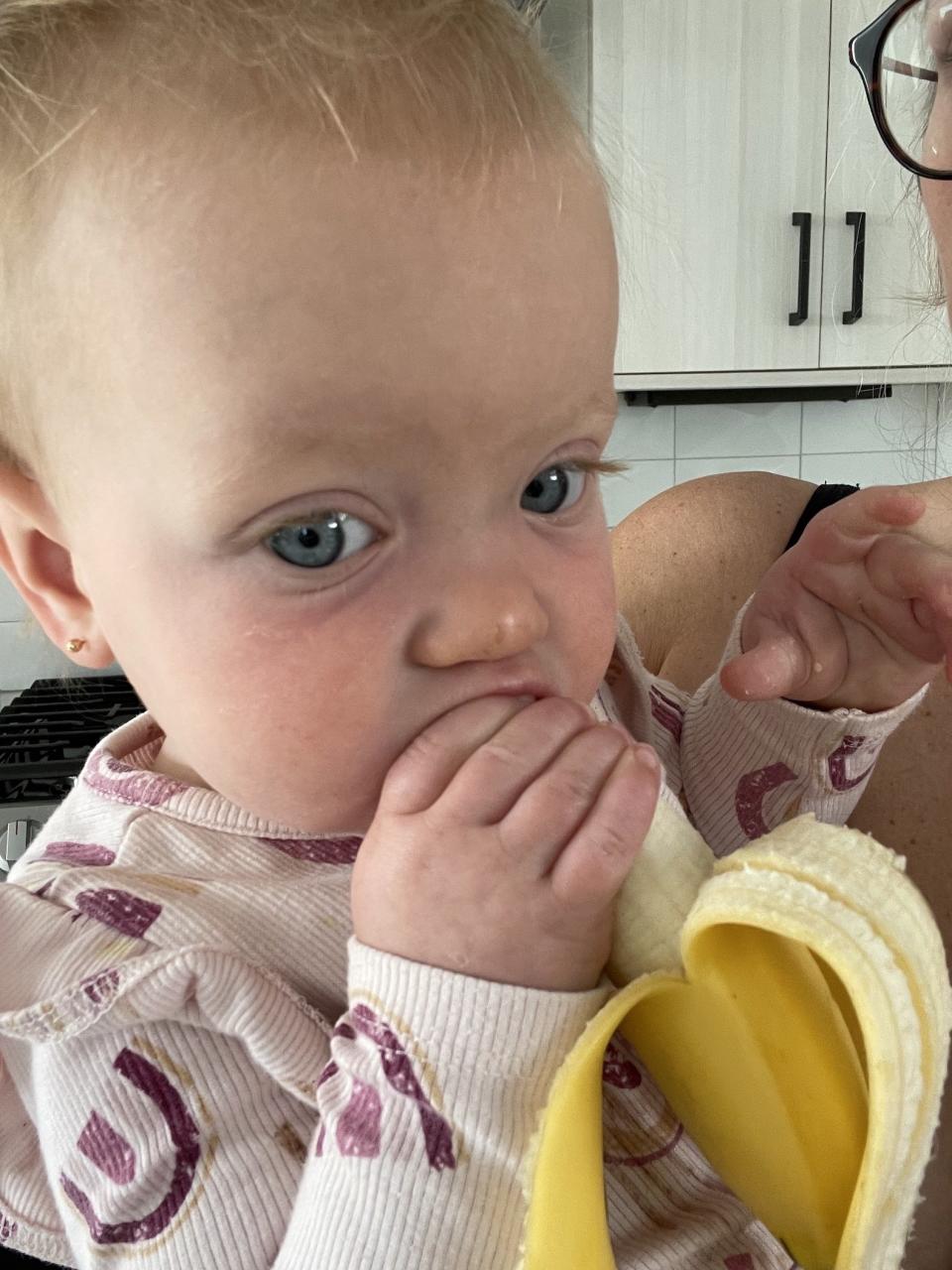 The author's kid eating a banana
