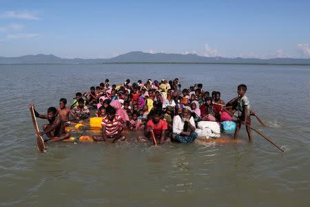 Rohingya refugees cross the Naf River with an improvised raft to reach to Bangladesh at Sabrang near Teknaf, Bangladesh November 10, 2017. REUTERS/Mohammad Ponir Hossain/Files