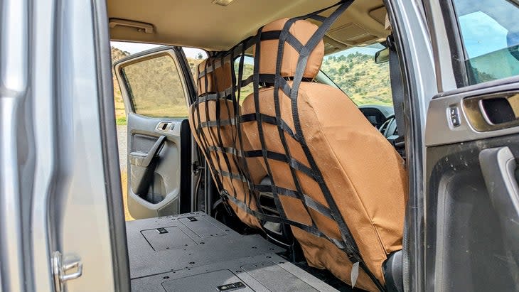 <span class="article__caption">The Raingler cargo net wraps the B-pillar and seat mounts, the strongest possible parts of the vehicle. The seat covers are handmade by <a href="https://www.marathonseatcovers.com/" rel="nofollow noopener" target="_blank" data-ylk="slk:Marathon;elm:context_link;itc:0;sec:content-canvas" class="link ">Marathon</a>, in Bozeman, Montana. </span>