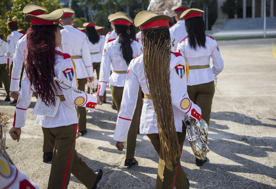 FILE - In this Oct. 25, 2018 file photo, the honor guard military band march after the arrival of El Salvador's President Salvador Sanchez Ceren at Revolution Square in Havana, Cuba. (AP Photo/Desmond Boylan, File)