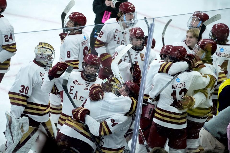 The Boston College Eagles celebrate their 5-4 overtime win in the NCAA Regional hockey final at the AMP on Sunday evening.