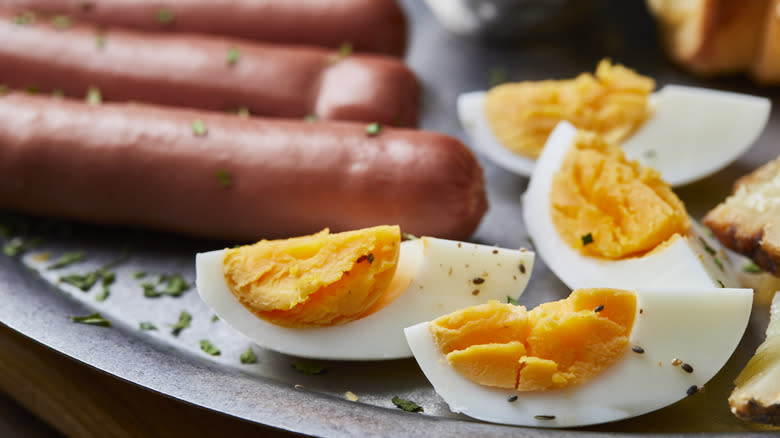 grilled eggs next to hot dogs