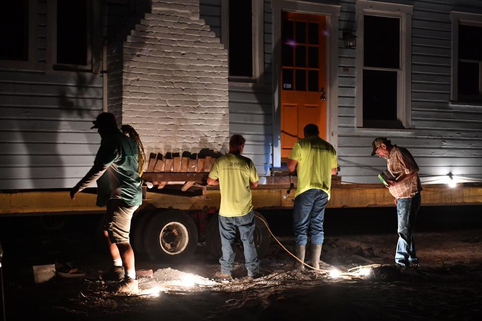 A crew from Johnson House Moving attach lights to the outside of the Leonard Reid House before beginning the move. The historic Leonard Reid House was relocated early Friday morning from 7th Street in the Rosemary District to a City of Sarasota-owned lot on Dr. Martin Luther King Way and Orange Avenue in  Sarasota, where it will become the first home for a new Sarasota African American cultural arts center.