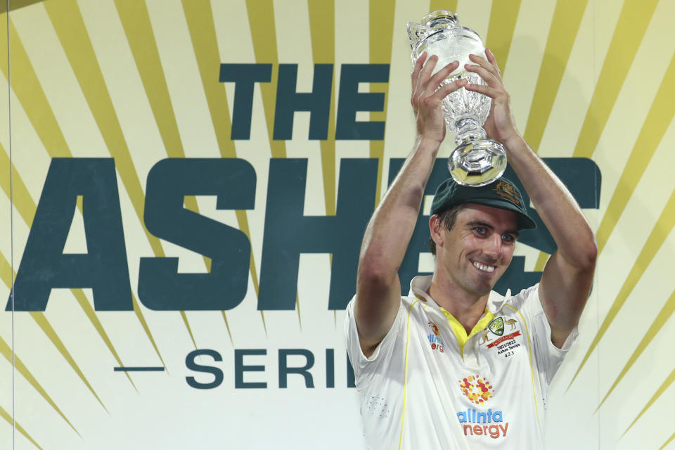 Australia's captain Pat Cummins hold the trophy after winning the Ashes cricket match and the series against England in Hobart, Australia, Sunday, Jan. 16, 2022. (AP Photo/Tertius Pickard)