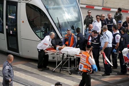 Israeli medics evacuate a wounded Palestinian minor, who police said stabbed an Israeli security guard, in Pisgat Zeev, which lies on occupied land that Israel annexed to Jerusalem after the 1967 Middle East war, November 10, 2015. REUTERS/Ammar Awad