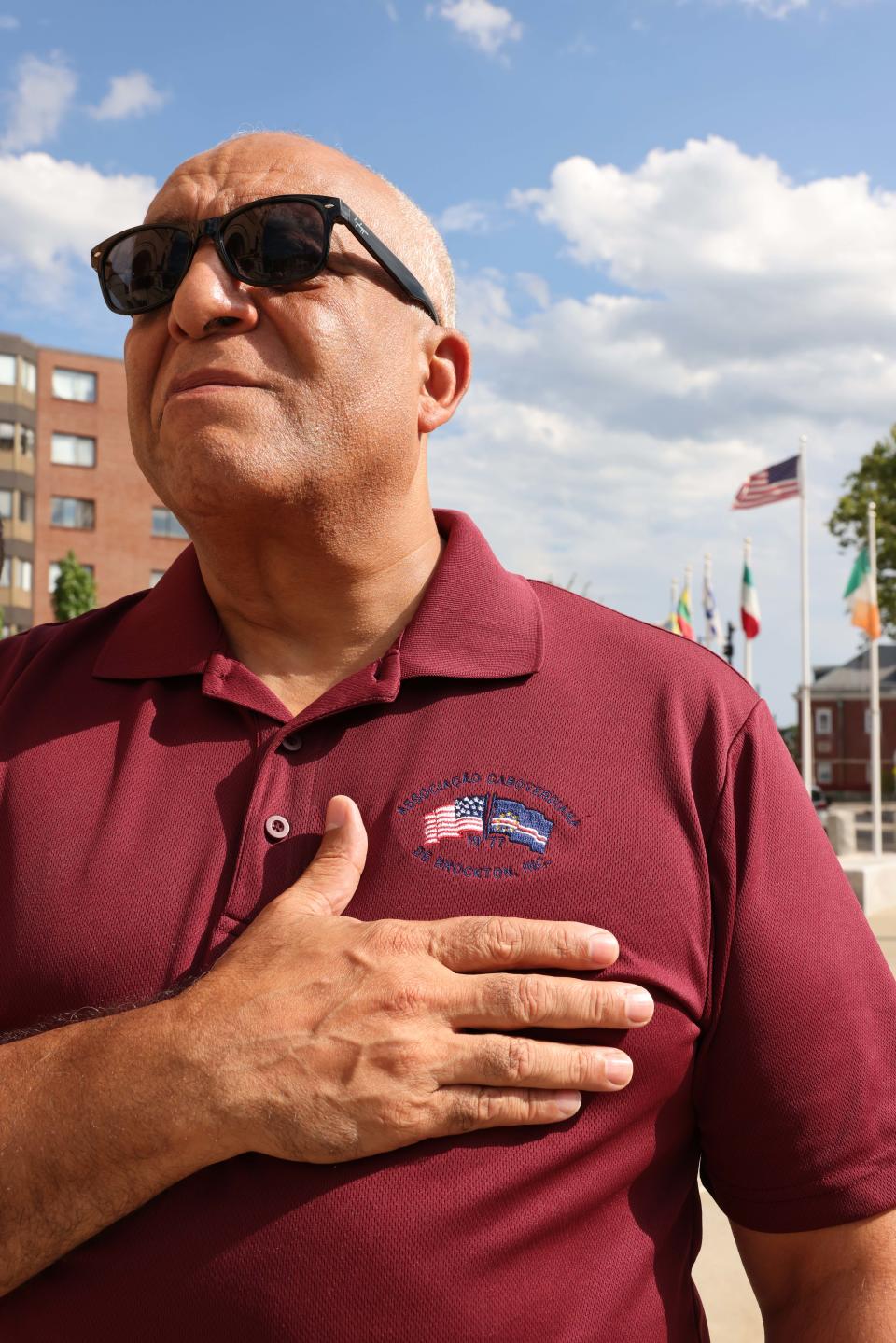 Councilor-at-large Moises Rodrigues holds his hand over his heart as the national anthem plays at Cape Verde Flag Day at Brockton City Hall Plaza on Friday, July 29, 2022.