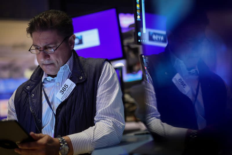 Traders work on the floor of the NYSE in New York