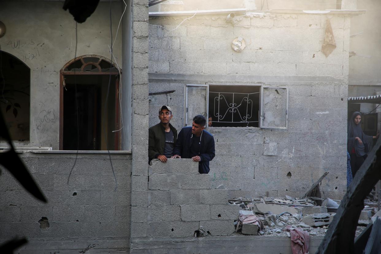 Palestinians look out of a house damaged in an Israeli strike in Rafah, southern Gaza (REUTERS)