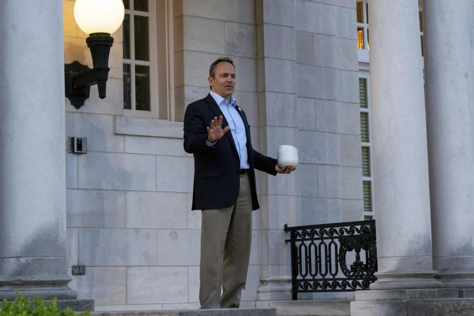 Kentucky Gov. Matt Bevin arrives at his election night news conference carrying bowls, offering the media chili, after winning the Republican gubernatorial primary, in Frankfort, Ky., Tuesday, May 21, 2019. (AP Photo/Bryan Woolston)