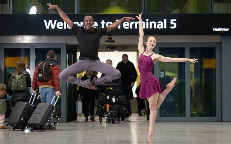Shevelle Dynott and Alison Eager perform a Christmas ballet titled 'The Reunion' at Heathrow Terminal 5 Arrivals