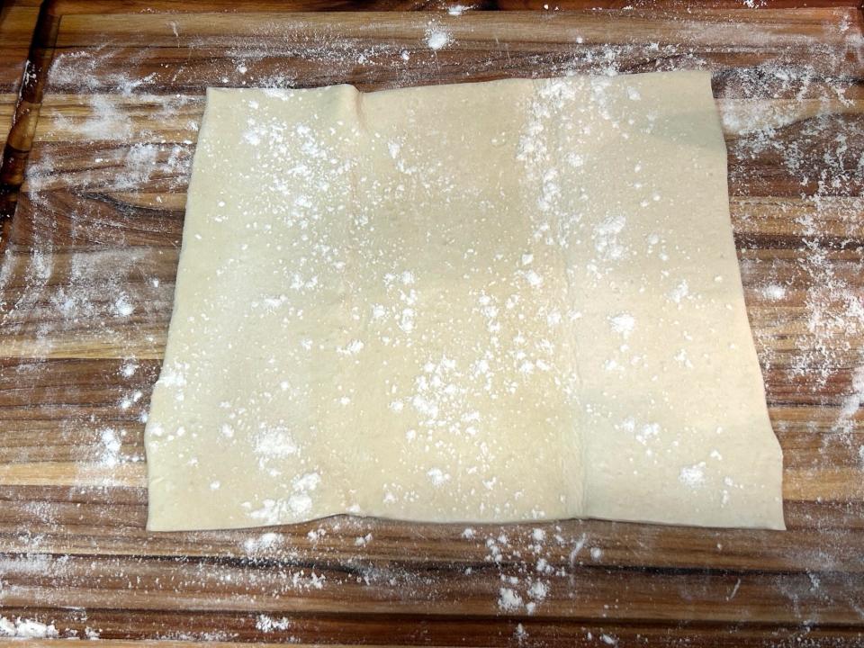 Rolling out puff pastry for croutons in Ina Garten's chicken pot pie soup