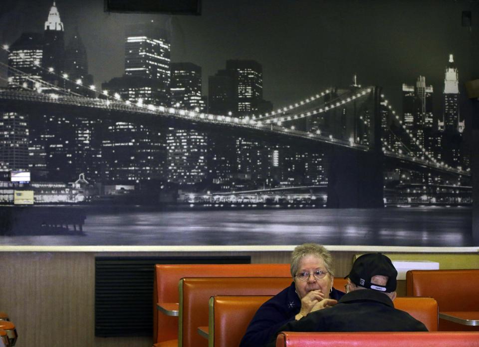 In this Monday, March 3, 2014 photo Joan Vear and John Iaciofano eat lunch under a mural of New York City's Brooklyn Bridge at Olneyville New York System of Providence in Providence, R.I. The James Beard Foundation named the Rhode Island restaurant one of five "American Classics". (AP Photo/Stephan Savoia)