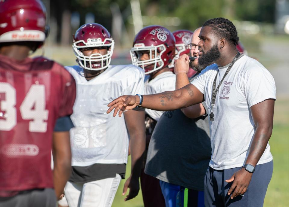 New Tigers head coach Martes Wheeler instructs players during football practice at Pensacola High School on Monday, Oct. 2, 2023.