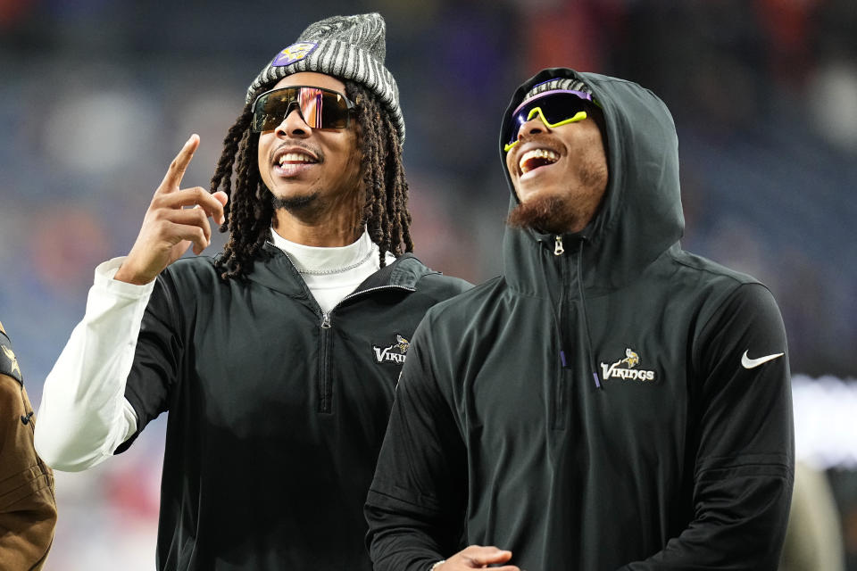 Minnesota Vikings wide receiver Justin Jefferson, right, and wide receiver Trishton Jackson watch from the sidelines prior to an NFL football game against the Denver Broncos, Sunday, Nov. 19, 2023, in Denver. (AP Photo/Jack Dempsey)