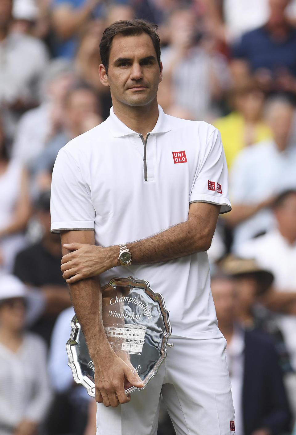 Switzerland's Roger Federer holds the runners up trophy during the presentation after he was defeated by Serbia's Novak Djokovic during the men's singles final match of the Wimbledon Tennis Championships in London, Sunday, July 14, 2019. (Laurence Griffiths/Pool Photo via AP)