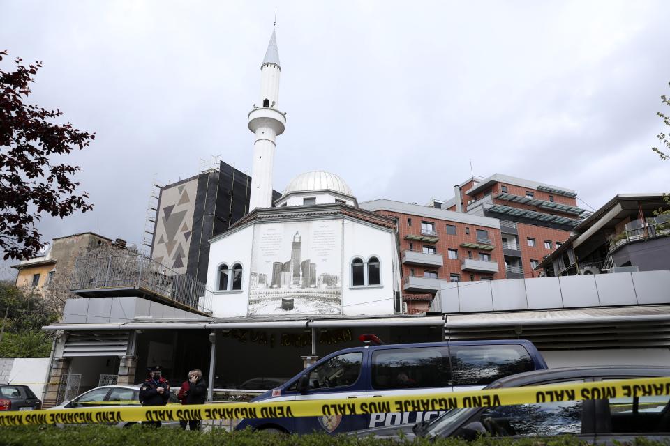 Police stand outside Dine Hoxha mosque after a knife attack in Tirana, Albania, Monday, April 19, 2021. Police say an Albanian man with a knife has attacked five people at a mosque in the capital of Tirana. A police statement said Rudolf Nikolli, 34, entered the Dine Hoxha mosque in downtown Tirana about 2:30 p.m. and wounded five people with a knife. (AP Photo)