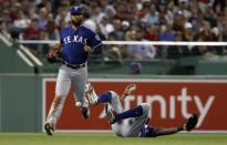 Jul 11, 2018; Boston, MA, USA; Texas Rangers left fielder Delino DeShields (3) goes tumbling as he is unable to come up with a single by Boston Red Sox second baseman Eduardo Nunez (not pictured) as third baseman Joey Gallo (left) looks on during the seventh inning at Fenway Park. Mandatory Credit: Winslow Townson-USA TODAY Sports