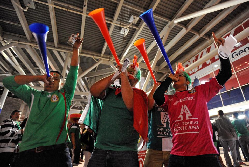 Soccer fans blow vuvuzelas before an international friendly soccer match between Mexico and Nigeria on Wednesday, March 5, 2014, in Atlanta. (AP Photo/David Tulis)