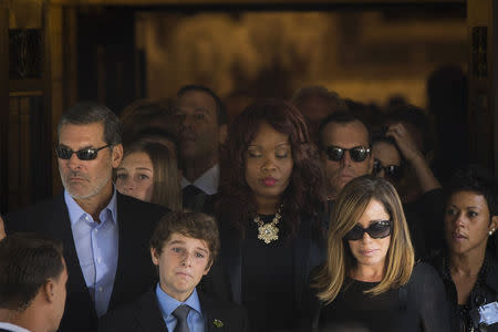 Melissa Rivers and her son Cooper depart the funeral of her mother, comedian Joan Rivers, at Temple Emanu-El in New York September 7, 2014. REUTERS/Lucas Jackson
