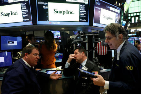 Traders work on the floor of the New York Stock Exchange (NYSE) while waiting for Snap Inc. will post their IPO in New York, U.S., March 2, 2017. REUTERS/Lucas Jackson